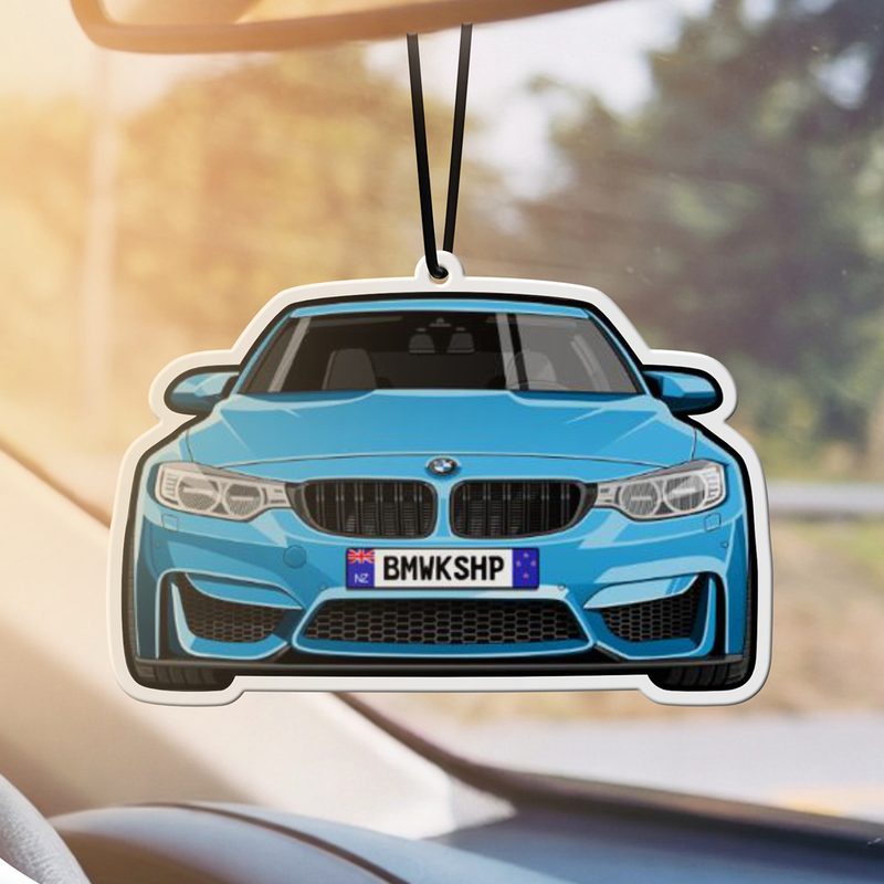 Custom cartoon car air freshener hanging from a rear view mirror