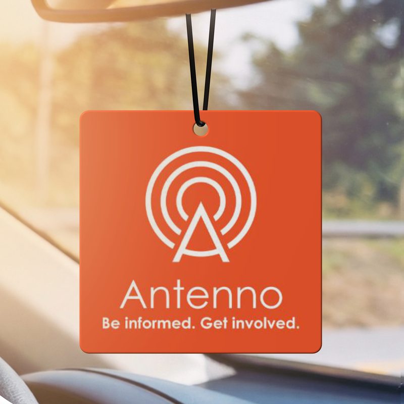 Logo air freshener hanging from a rear view mirror